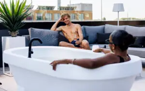 Auralis Living white Gardentub with 2 people enjoying the luxury of an outdoor bathtub