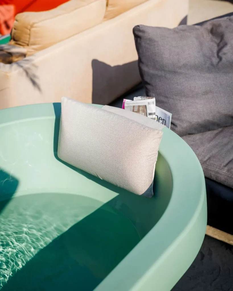 Auralis Living Gardentub light green outdoor bathtub with beige cushion and storage pocket
